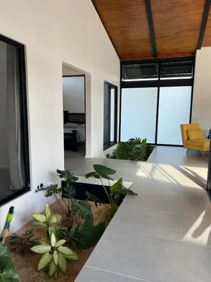 an open living room with a couch and plants at Guanacaste Marbella luxury home with a private pool in Santa Cruz