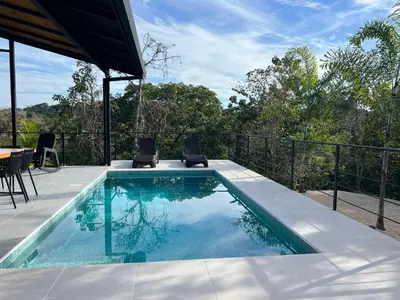 a swimming pool with a table and chairs next to it at Guanacaste Marbella luxury home with a private pool in Santa Cruz