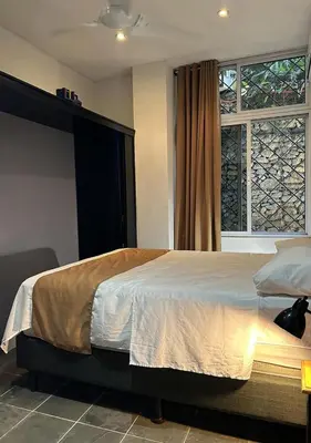a bedroom with a large bed and a window at Manuel Antonio Appartement 4 personnes Terrasse priv in Quepos