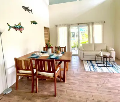 a living room with a wooden table and chairs at Paradiselodge - Casa Linda in Platanillo