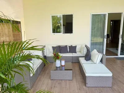 a patio with a couch and a table at Paradiselodge - Casa Linda in Platanillo