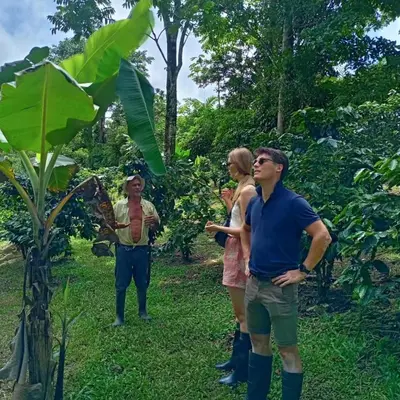 a group of people standing next to a tree at Starfruit House in Chachagua