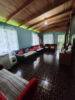 a living room with a couch and chairs in it at Casa La Esperanza in Chachagua