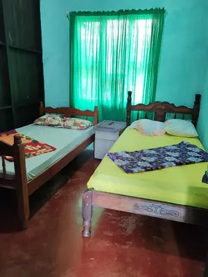 two beds sitting next to each other in a room at Casa La Esperanza in Chachagua