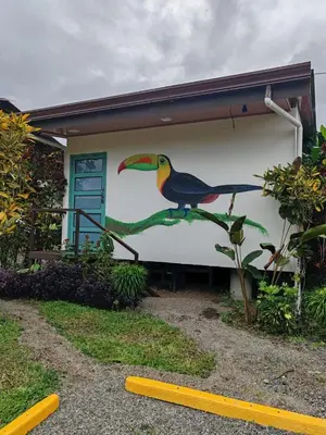 a painting of a bird on the side of a house at Bungalow Tucán & Jacuzzi in Fortuna