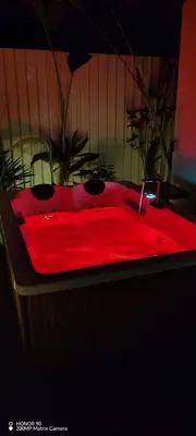 a red bath tub with a red counter top at Bungalow Tucán & Jacuzzi in Fortuna