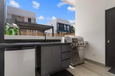 a kitchen with a sink and a stove at Chic Bohemian Villa with a Private Swimming Pool and Stunning Outdoor Space in Coco