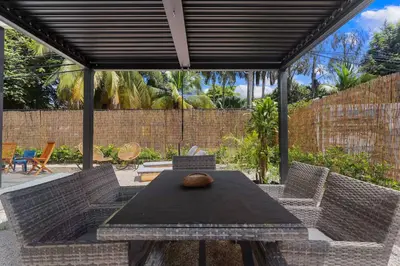 a patio with a table and chairs under a pergola at Chic Bohemian Villa with a Private Swimming Pool and Stunning Outdoor Space in Coco