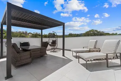 a patio with chairs and a gazebo at Chic Bohemian Villa with a Private Swimming Pool and Stunning Outdoor Space in Coco