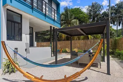 a hammock in front of a house at Chic Bohemian Villa with a Private Swimming Pool and Stunning Outdoor Space in Coco