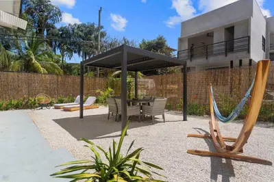 a patio with a hammock and a house at Chic Bohemian Villa with a Private Swimming Pool and Stunning Outdoor Space in Coco