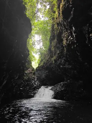 a creek in a cave with a waterfall at Tropical Crystal House in Guápiles
