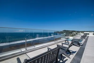 a row of benches sitting on top of a building at Stylish 1-BR Oceanfront Condo with Panoramic Views in Jacó