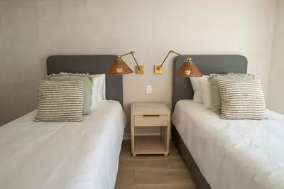 two beds sitting next to each other in a room at Stylish 2-BR Oceanfront Condo with Panoramic Views in Jacó