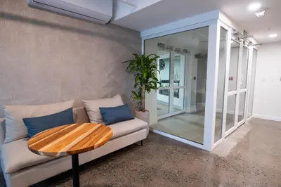 a living room with a couch and a wooden table at Stylish 2-BR Oceanfront Condo with Panoramic Views in Jacó