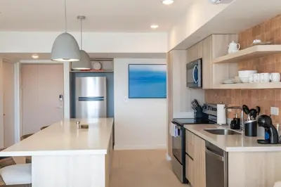a kitchen with a sink and a counter top at Stylish 2-BR Oceanfront Condo with Panoramic Views in Jacó