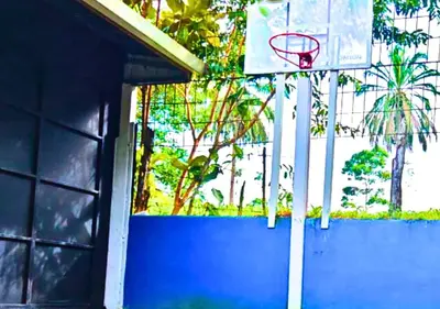 a basketball hoop in front of a building at Peace of the forest in Llano Grande