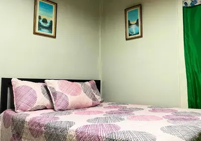 a bedroom with a bed and two pictures on the wall at Peace of the forest in Llano Grande