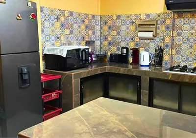 a kitchen with a black refrigerator and a microwave at Peace of the forest in Llano Grande