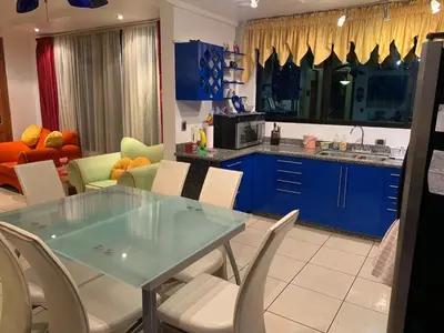 a kitchen with blue cabinets and a table and chairs at Modern Mediterranean Santorini House in Cartago