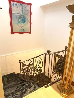 a staircase with a painting on the wall and a picture on the wall at Modern Mediterranean Santorini House in Cartago