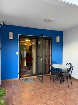 a dining room with a table and a blue wall at Condo Morpho with 2bed 2 baths in Coco