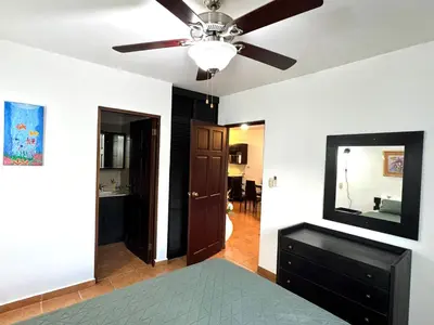 a bedroom with a ceiling fan and a mirror at Condo Morpho with 2bed 2 baths in Coco