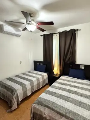 a bedroom with two beds and a ceiling fan at Condo Morpho with 2bed 2 baths in Coco