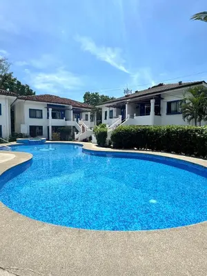 a large blue swimming pool in front of some houses at Condo Morpho with 2bed 2 baths in Coco