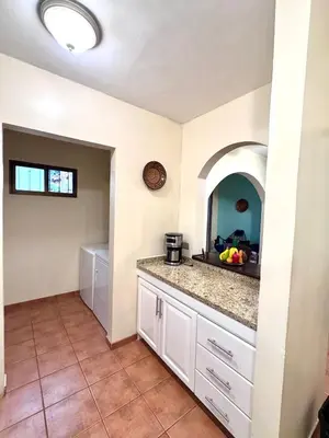 a kitchen with white cabinets and a counter top at Three Bedroom Spacious Townhome in Coco