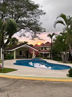 a swimming pool in front of a house at Three Bedroom Spacious Townhome in Coco