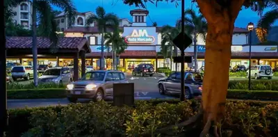 a street with cars parked in front of a building at Three Bedroom Spacious Townhome in Coco