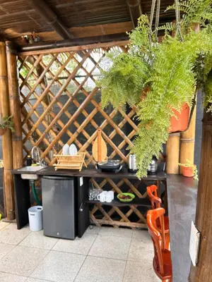 an outdoor kitchen with a table and a plant at Bambuk Bio Dome Uvita beach front in Uvita