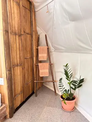 a room with a tent with a plant and two towels at Bambuk Bio Dome Uvita beach front in Uvita