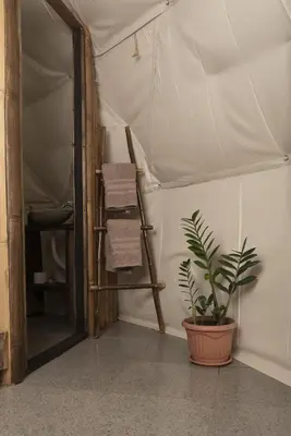 a room with a tent with a plant and a ladder at Bambuk Bio Dome Uvita beach front in Uvita