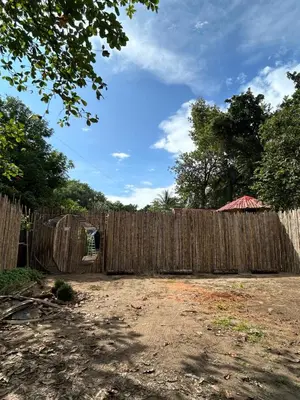a wooden fence in front of a yard at Bambuk Bio Dome Uvita beach front in Uvita
