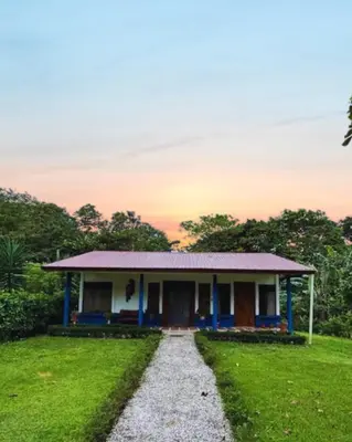 a small house with a gravel road in front of it at Casita El Almendro in Bijagua