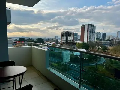 a balcony with a view of a city at Apartment in La Sabana in San José