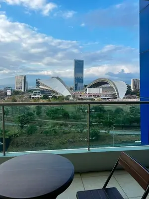 a view of a city from the balcony of a building at Apartment in La Sabana in San José