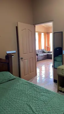 a bedroom with a bed and a living room at Fergust Family Studio Monteverde in Sierra