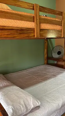 a bedroom with two bunk beds and a fan at Fergust Family Studio Monteverde in Sierra