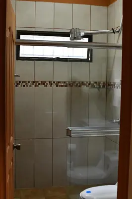 a glass shower in a bathroom with a window at Fergust Family Studio Monteverde in Sierra