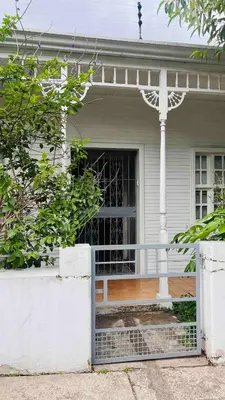 a front porch of a house with a gate at Casa Botánica de Aranjuez in San José