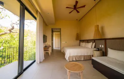 a hotel room with a bed and a balcony at Casa Lagom, Luxurious Oasis with Infinity Pool! in La Cruz