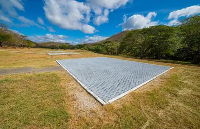 a metal grid on the ground in a field at Casa Lagom, Luxurious Oasis with Infinity Pool! in La Cruz