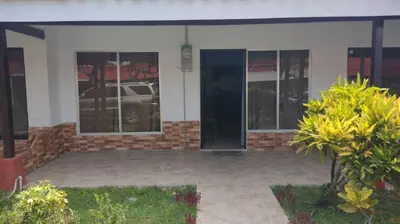 a house with a car parked inside of it at Villas jaco costa rica in Jacó