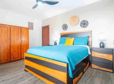 a bedroom with a bed with blue and yellow at Ocean Views-Private-Pool-Easy access-Ojochal-Gate in Ojochal