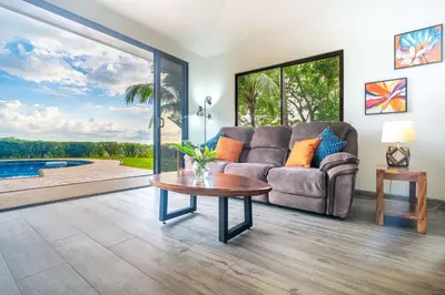 a living room with a couch and a table at Ocean Views-Private-Pool-Easy access-Ojochal-Gate in Ojochal