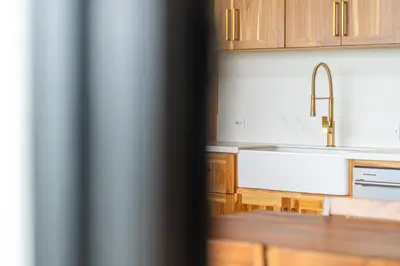 a kitchen with wooden cabinets and a sink at NEW! Luxury-4 Suites-Private pool-Ocean views in Coronado