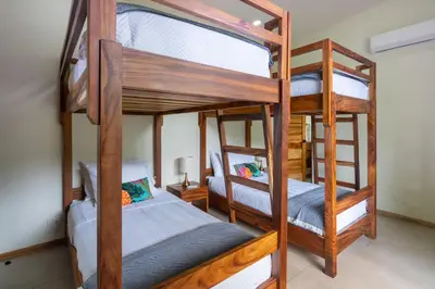 two bunk beds in a room with two beds at NEW! Luxury-4 Suites-Private pool-Ocean views in Coronado